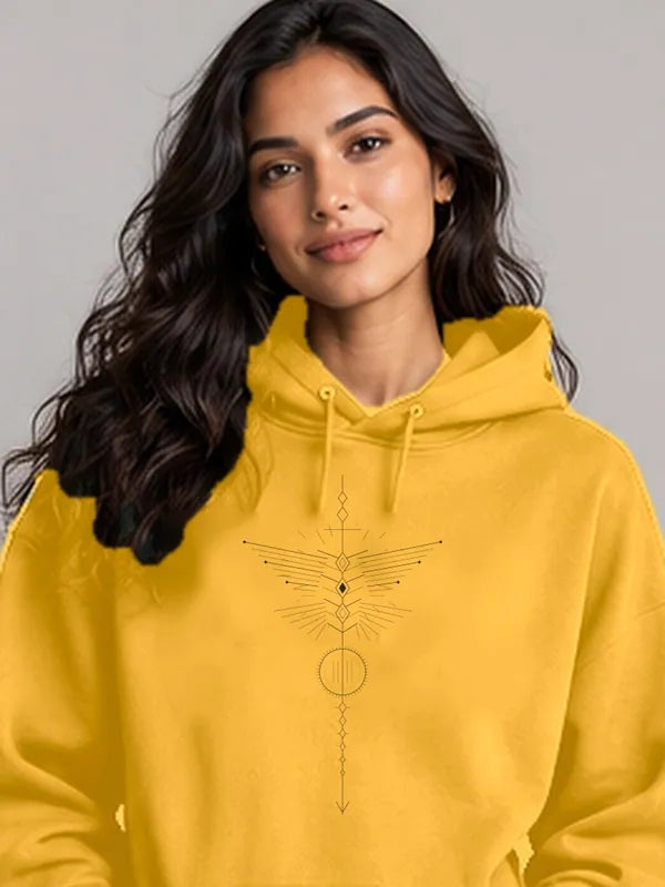 Model wearing the Oztra Totem Hoodie in mustard